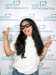 Girl with sunglasses posing making peace signs