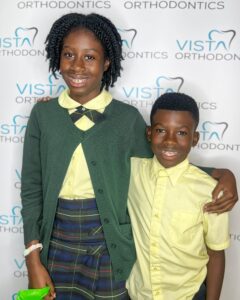 Siblings with braces posing for camera