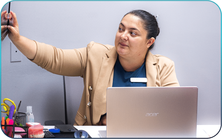 a woman sitting at a desk with a laptop